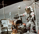 image of an astronaut standing next to the luar lander on the moon