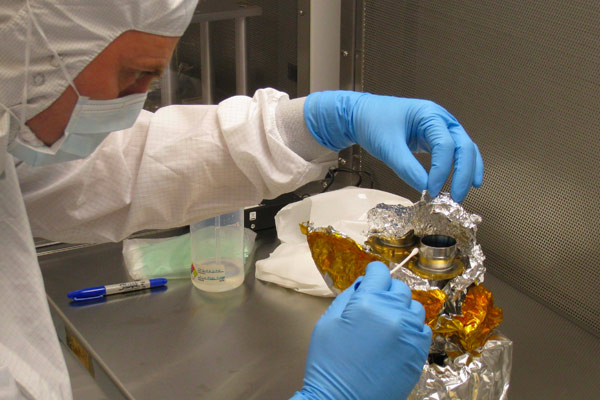 Andrew Steele (Carnegie Institution of Washington) taking a swab of the outer surface of the SAM solid sample inlet. The swab sampling of the SAM solid sample inlet tubes was done in the clean room for microbiological analyses to demonstrate that the SAM inlets were clean and satisfied the planetary protection requirements.
